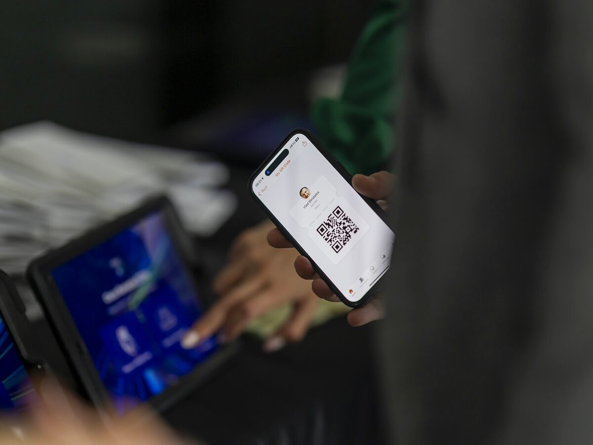 Attendee presenting a mobile QR code for event access.