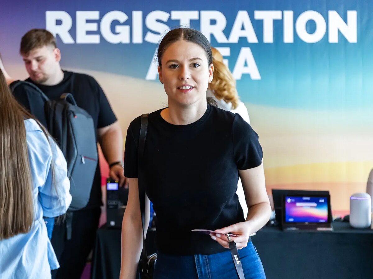 Registration staff welcoming participants at a business event.