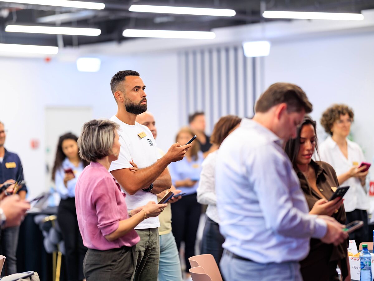 Participants are using LinkO on their phones during an interactive networking session.