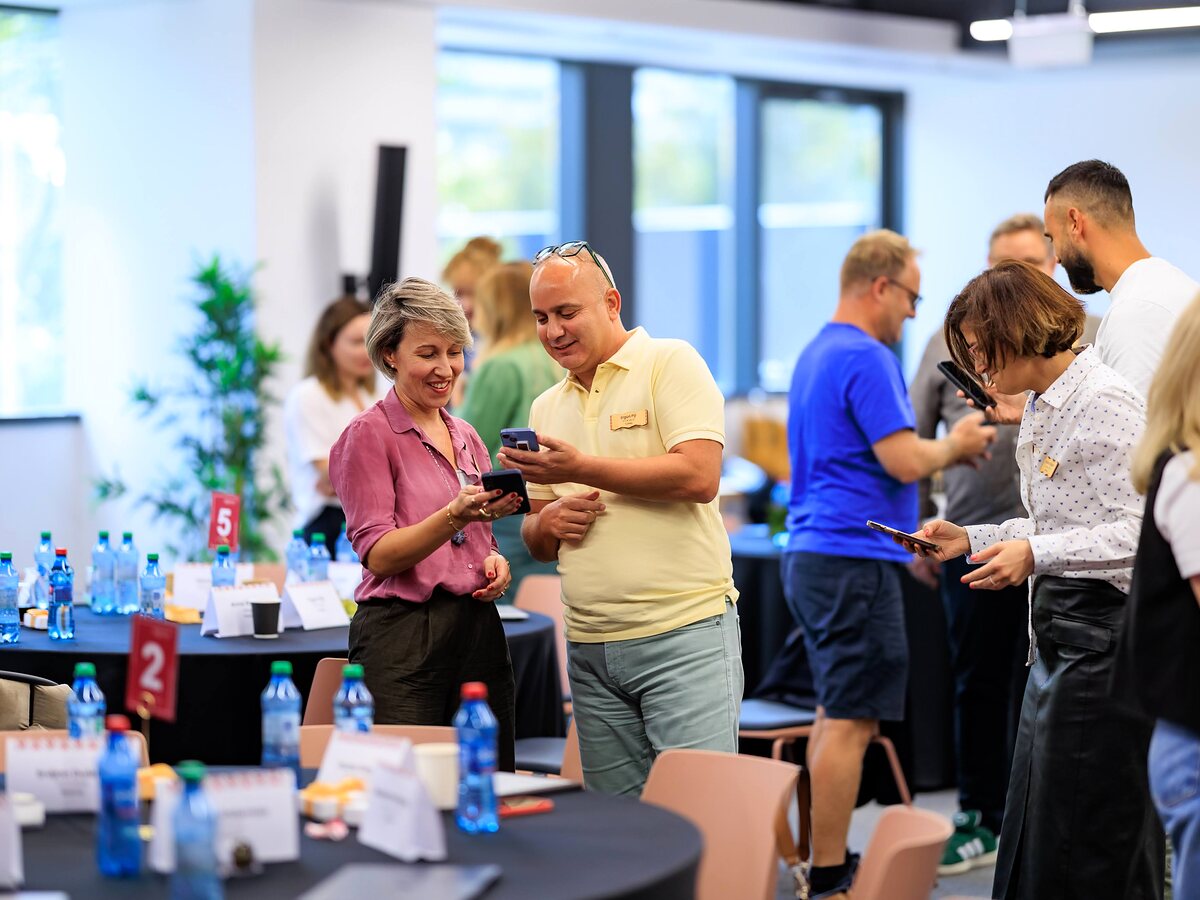 Groups of participants are playing LinkO during an interactive activity at the event.