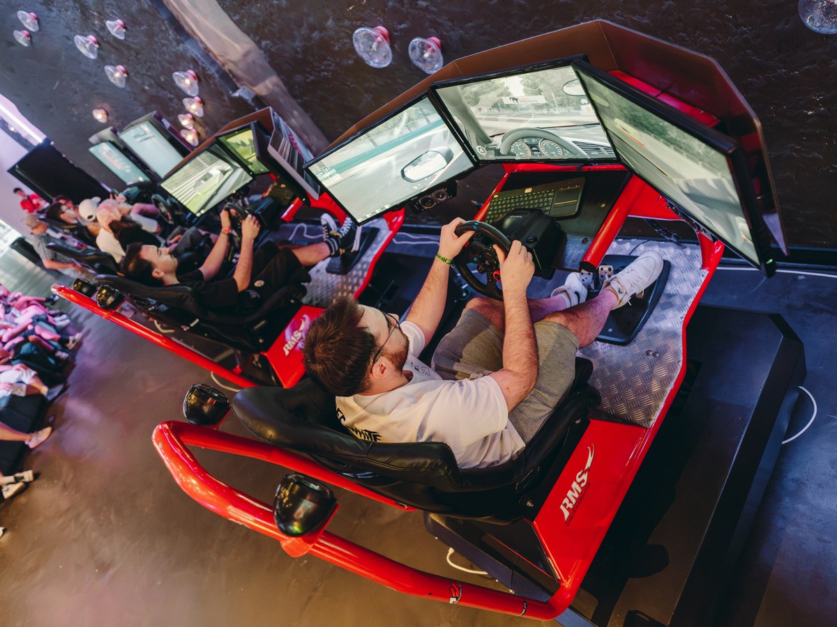 Participant using the racing simulator in the RESPAWN area